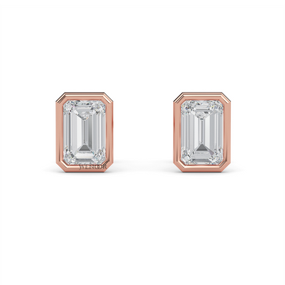 Woman wearing emerald cut bezel stud lab diamond earrings – sustainable fine jewelry