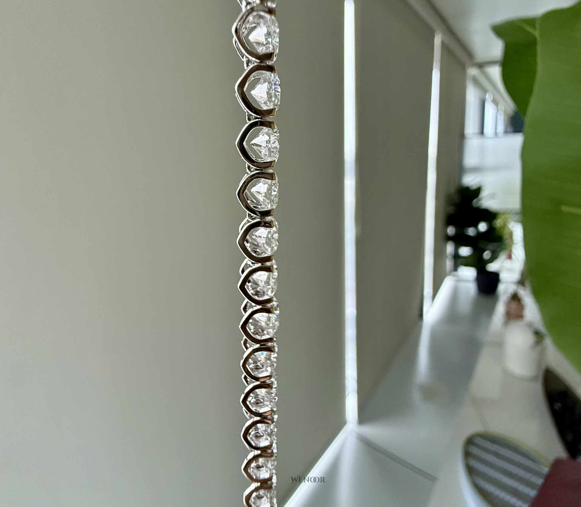 Lab grown diamond tennis bracelet with round stones in 14K gold four prong settings.