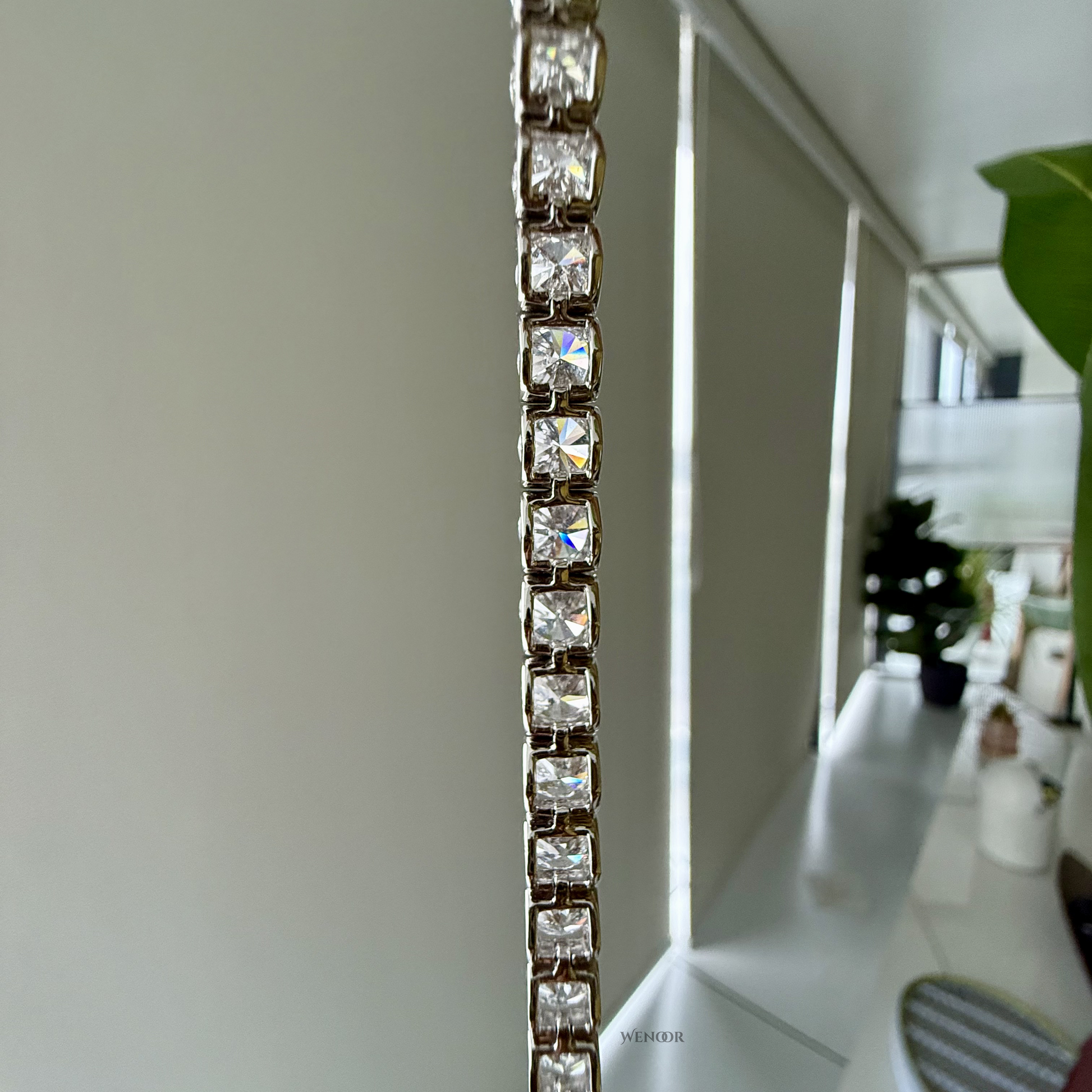 Lab grown diamond tennis bracelet with round stones in 14K gold four prong settings.