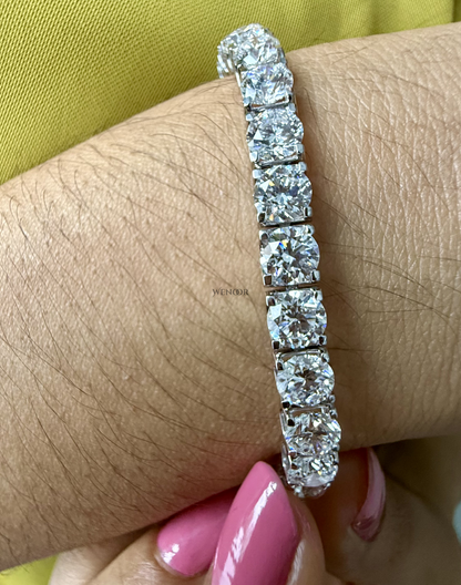 Lab grown diamond tennis bracelet with round stones in 14K gold four prong settings.