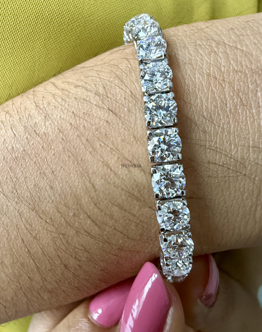 Lab grown diamond tennis bracelet with round stones in 14K gold four prong settings.