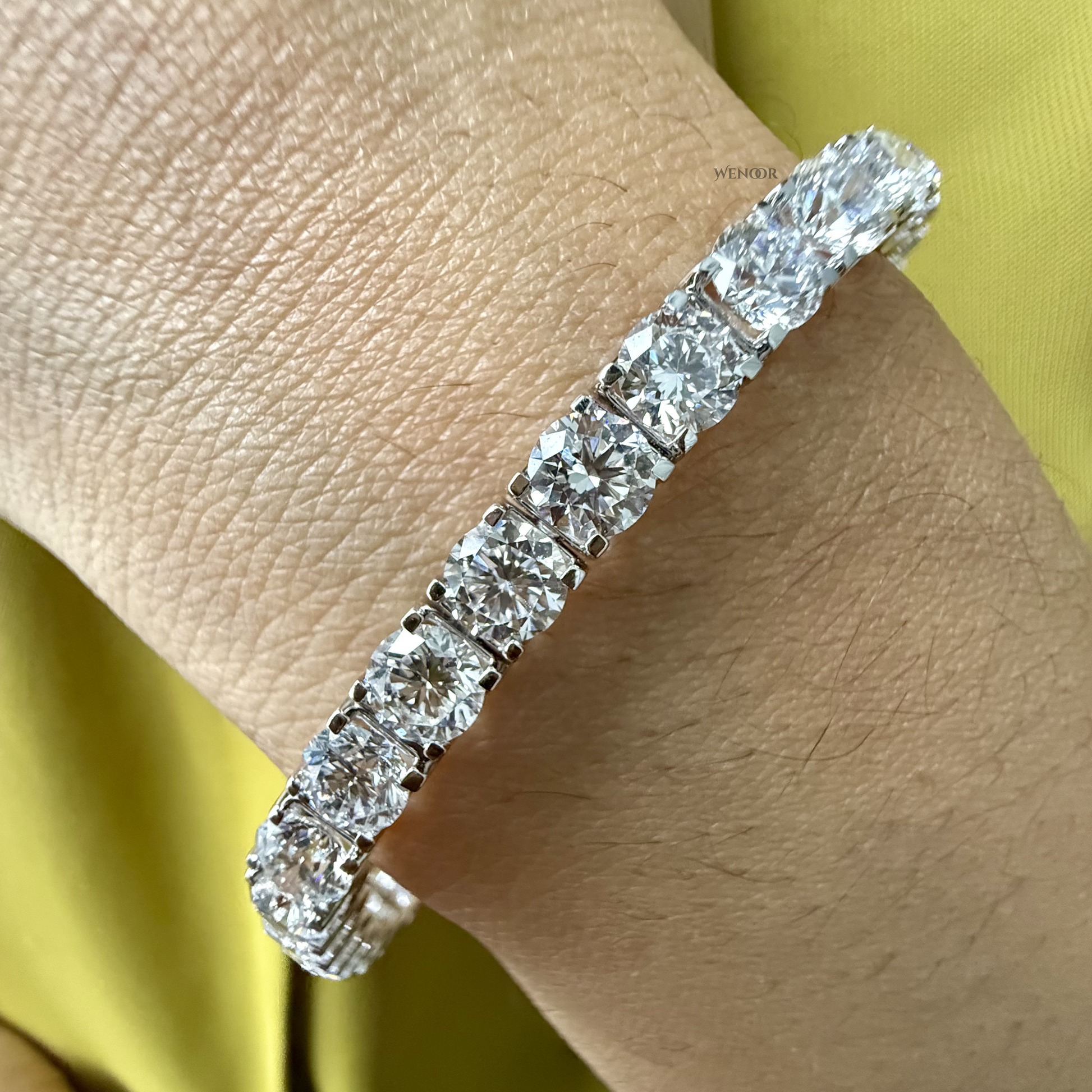 Lab grown diamond tennis bracelet with round stones in 14K gold four prong settings.