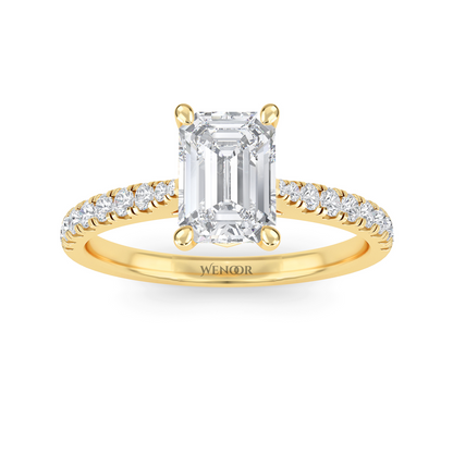 Amerald cut lab grown diamond ring with a gold band and accent side stones, featuring a brilliant step cut center stone