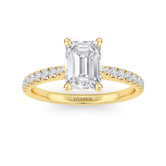 Amerald cut lab grown diamond ring with a gold band and accent side stones, featuring a brilliant step cut center stone