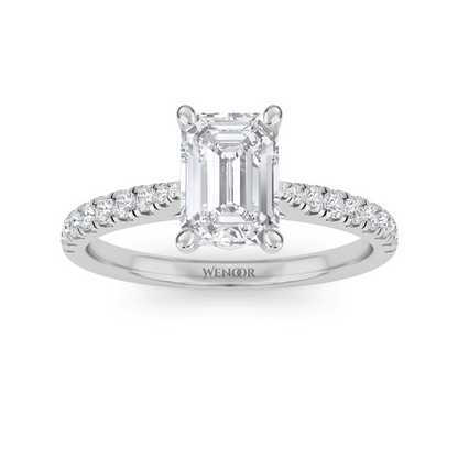 Amerald cut lab grown diamond ring with a gold band and accent side stones, featuring a brilliant step cut center stone