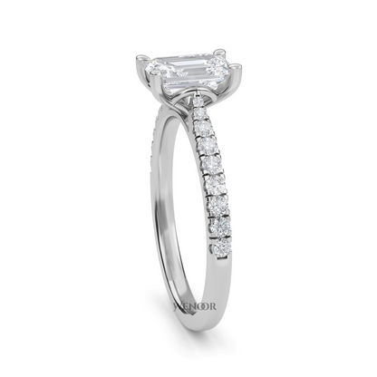 Amerald cut lab grown diamond ring with a gold band and accent side stones, featuring a brilliant step cut center stone