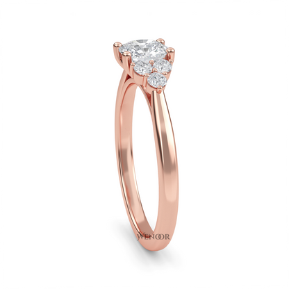 At wenoor Woman wearing cushion cut lab-grown diamond ring on hand, sunlight highlighting its fire and scintillation.