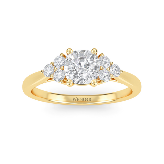 At wenoor Woman wearing cushion cut lab-grown diamond ring on hand, sunlight highlighting its fire and scintillation.
