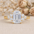 Emerald cut IGI certified lab grown diamond solitaire engagement ring in 14K yellow gold on a white background.