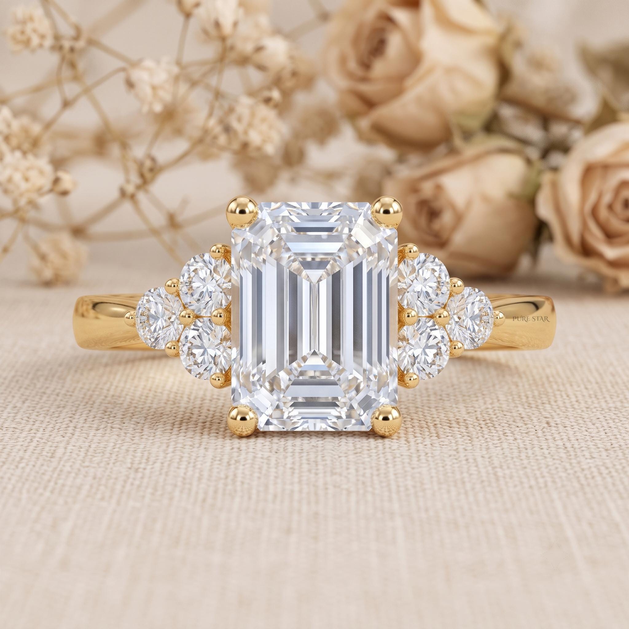 Emerald cut IGI certified lab grown diamond solitaire engagement ring in 14K yellow gold on a white background.