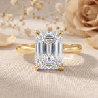 Emerald cut lab grown diamond engagement ring in 14K yellow gold solitaire setting on a white background.