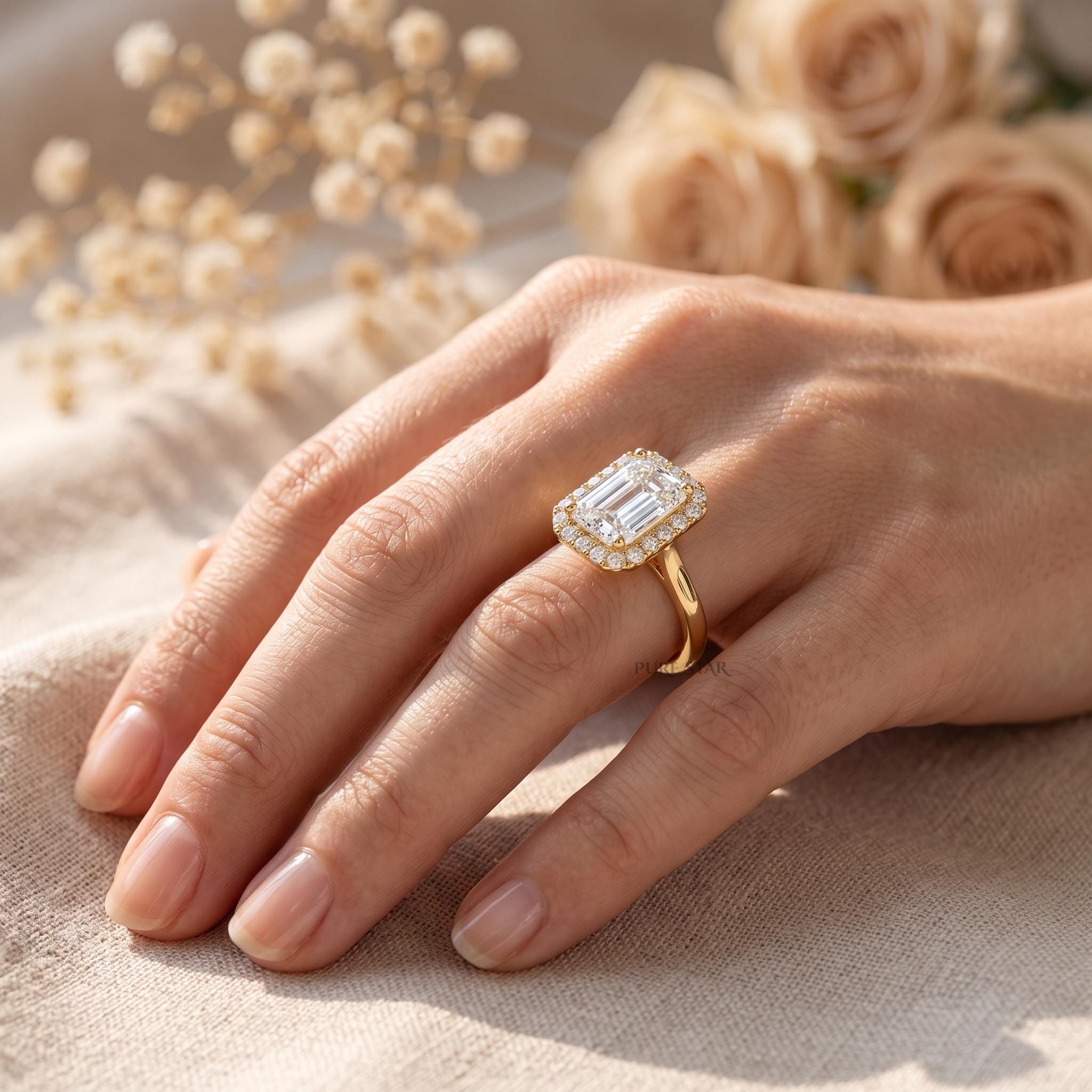 Solid gold emerald cut halo engagement ring with IGI certified diamond on a white background.
