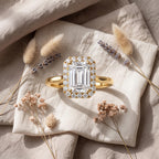 Luxury emerald cut diamond halo wedding ring worn on a woman's hand in natural light.