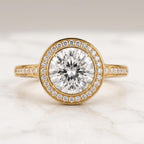 Round cut solitaire engagement ring with hidden halo crafted in 18K rose gold for bridal jewelry.