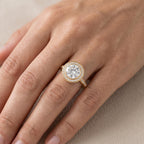 Handmade round brilliant lab grown diamond engagement ring in solid white gold on a luxury jewelry display.