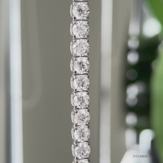Lab grown diamond tennis bracelet with round stones in 14K gold four prong settings.