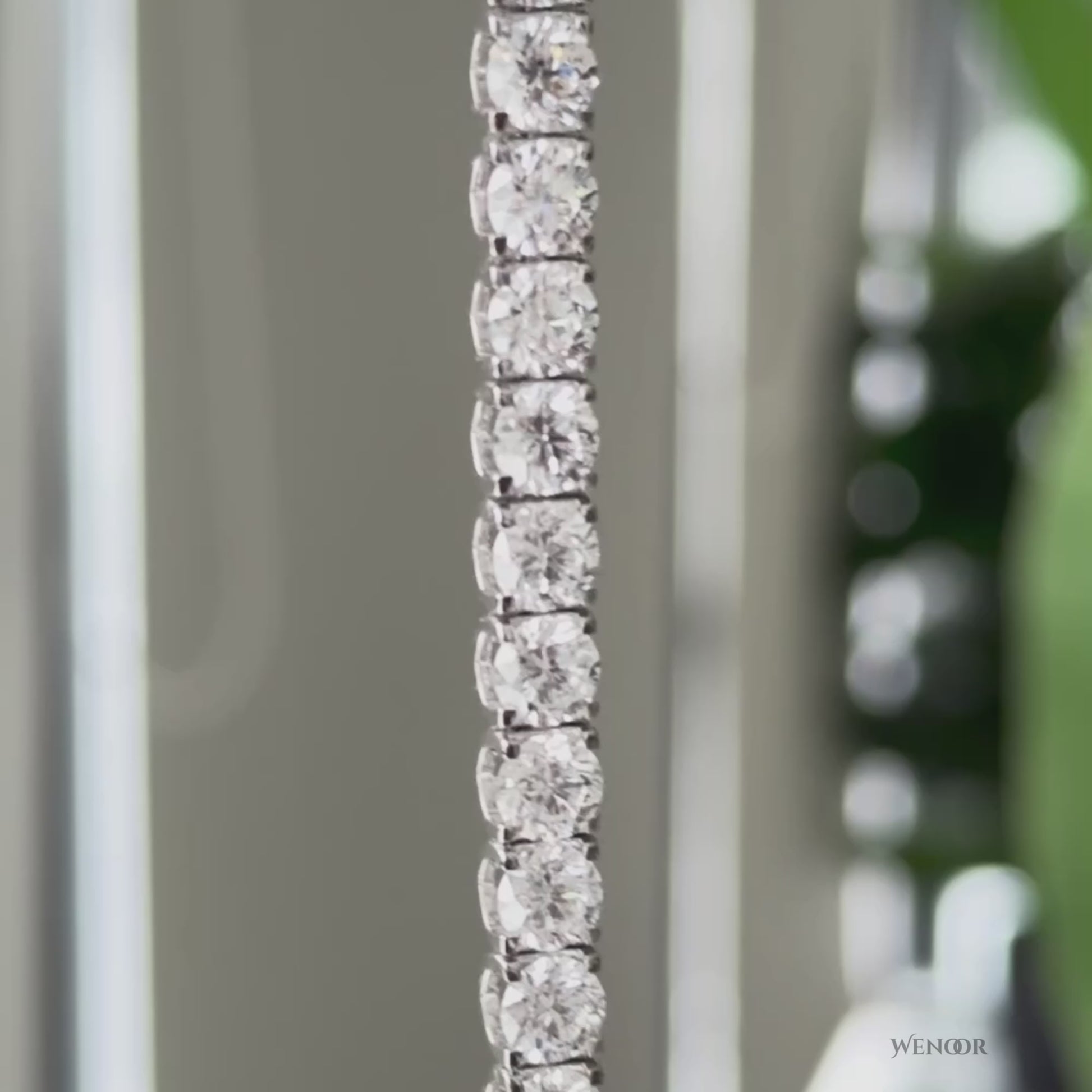 Lab grown diamond tennis bracelet with round stones in 14K gold four prong settings.