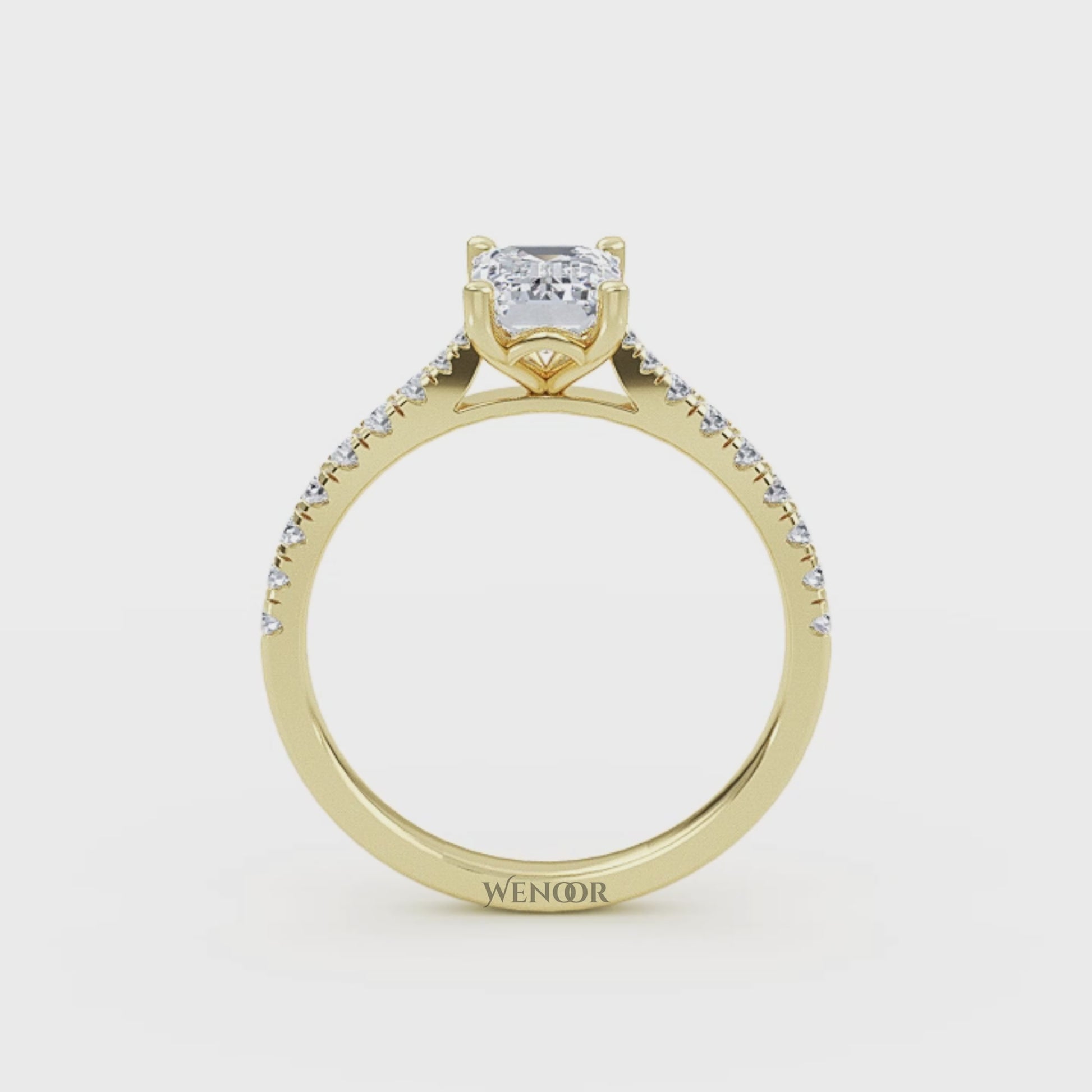 Amerald cut lab grown diamond ring with a gold band and accent side stones, featuring a brilliant step cut center stone