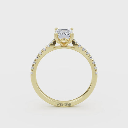 Amerald cut lab grown diamond ring with a gold band and accent side stones, featuring a brilliant step cut center stone