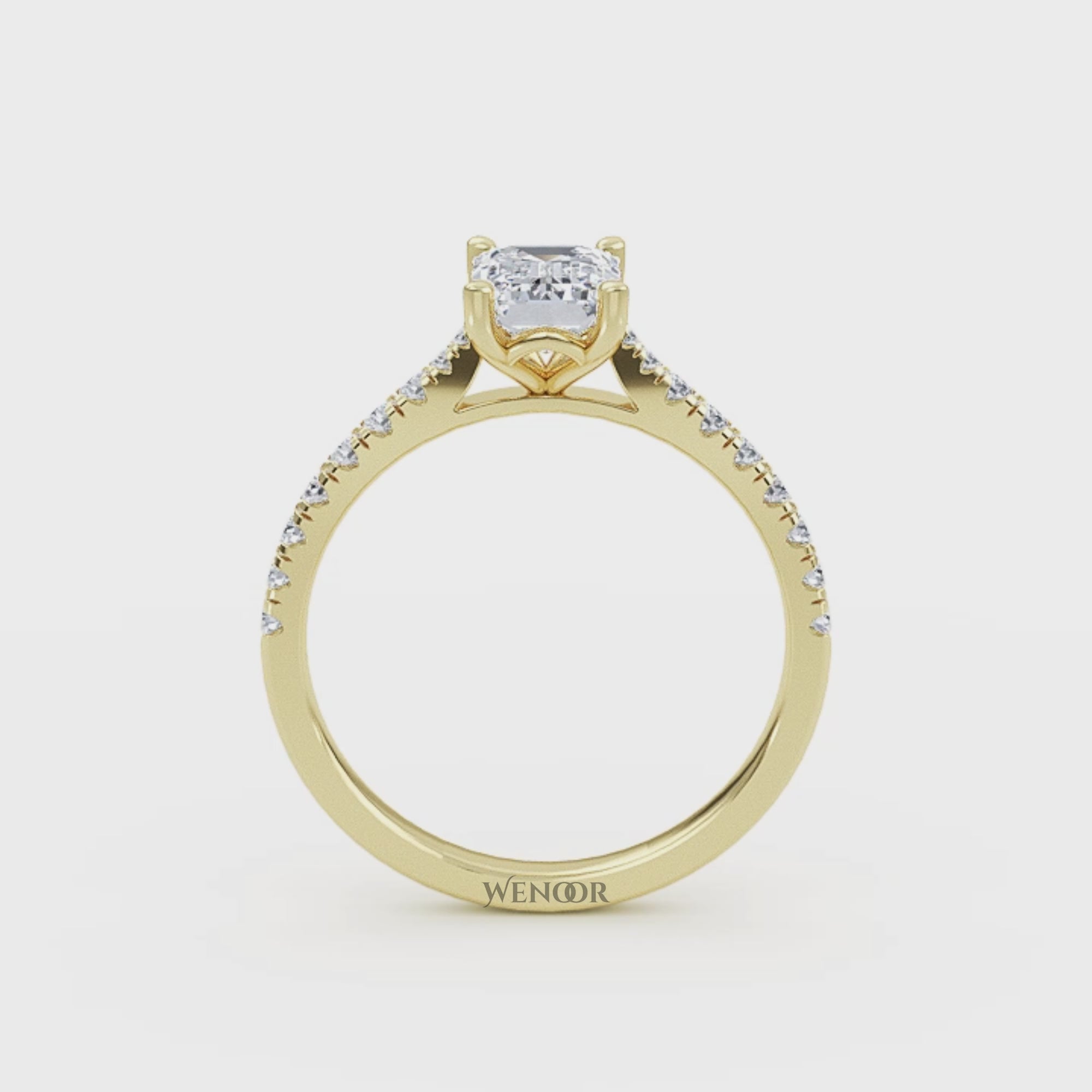 Amerald cut lab grown diamond ring with a gold band and accent side stones, featuring a brilliant step cut center stone