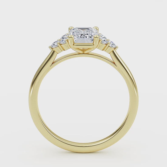 Woman wearing emerald cut lab-grown diamond ring on hand, showcasing sustainable luxury