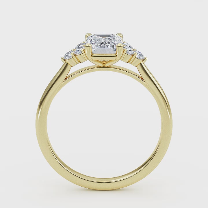 Woman wearing emerald cut lab-grown diamond ring on hand, showcasing sustainable luxury