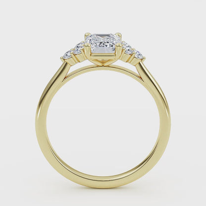 Woman wearing emerald cut lab-grown diamond ring on hand, showcasing sustainable luxury