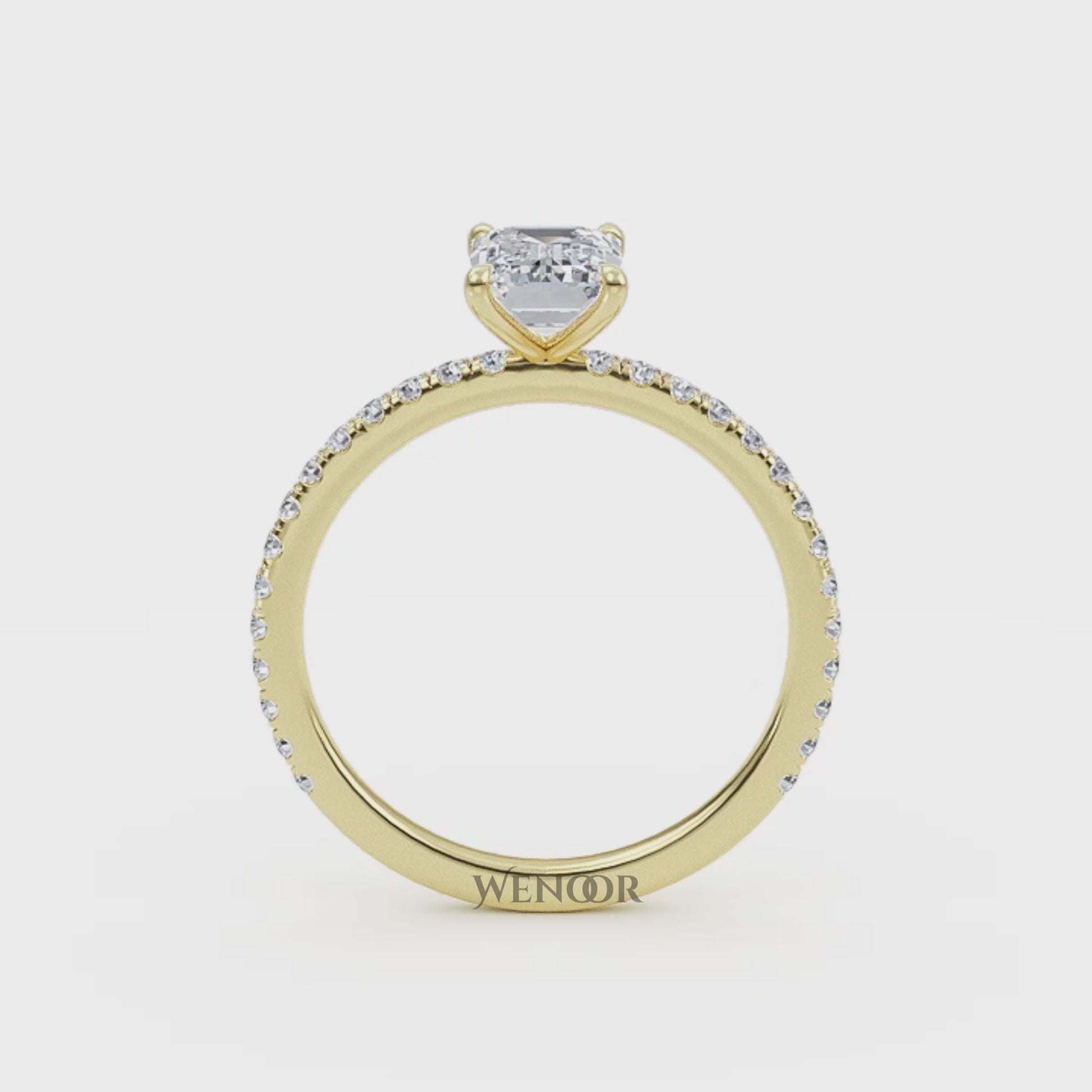 Bride's hand wearing emerald cut lab diamond engagement ring